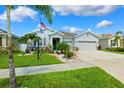 Charming single-story home featuring a well-manicured lawn, Florida landscaping, and a two-car garage at 537 Ocean Spray Dr, Ruskin, FL 33570