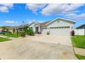 Charming single-story home featuring a well-manicured lawn, Florida landscaping, and a two-car garage at 537 Ocean Spray Dr, Ruskin, FL 33570