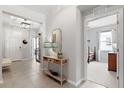 Bright foyer with tile flooring, decorative console table, and views of the entry and a secondary bedroom at 537 Ocean Spray Dr, Ruskin, FL 33570