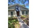 Inviting single-story home features neutral exterior paint, awning, and an easy-to-navigate walkway to the front door at 6214 Dewdrop Way # 621, Temple Terrace, FL 33617