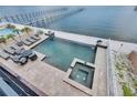 Inviting backyard features a pool, spa, lounge chairs, and waterfront views at 6418 Bright Bay Ct, Apollo Beach, FL 33572