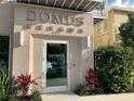 Entrance to building with 'Domus Urbana' signage, door, and decorative greenery at 644 3Rd S Ave # 402, St Petersburg, FL 33701