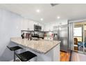 Eat-in kitchen with granite countertops, stainless steel appliances, and backyard access at 6681 121St Ave # I, Largo, FL 33773