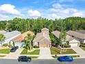 Aerial view of a residential neighborhood featuring well-maintained homes and lush landscaping, showcasing community appeal at 7606 Berna Ln, Land O Lakes, FL 34637