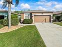 Lovely single-Gathering home showcasing manicured landscaping, a two-car garage, and inviting curb appeal at 7606 Berna Ln, Land O Lakes, FL 34637