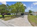 Inviting single-story home with a well-manicured lawn and a paved driveway at 7704 Tanglewood Ln, Tampa, FL 33615