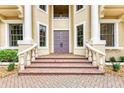 Close-up of the main entrance showing the impressive brick stairs, elegant railings, and double front door at 7803 Mathern Ct, Lakewood Ranch, FL 34202
