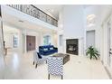 Bright, expansive living room with a soaring ceiling, fireplace, and elegant decor at 7803 Mathern Ct, Lakewood Ranch, FL 34202