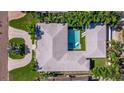 Aerial view showcasing a private pool, spa, and modern outdoor living space surrounded by lush landscaping at 827 Placido Ne Way, St Petersburg, FL 33704