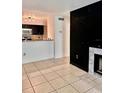 Open-concept living room with a modern fireplace, tile flooring, and neutral paint at 9481 Highland Oak Dr # 1101, Tampa, FL 33647