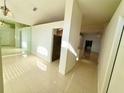 Bright foyer with tile flooring, large mirror, and open access to adjacent living spaces at 9614 Long Meadow Dr, Tampa, FL 33615