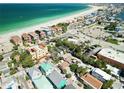 Gorgeous aerial view of beachfront homes and businesses along the serene coastline and bright blue ocean at 100 94Th Ave, Treasure Island, FL 33706