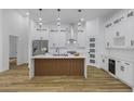 Spacious kitchen with stainless appliances, a large island and stylish light fixtures at 1213 E Lemon St, Tarpon Springs, FL 34689