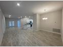 Bright and airy living room with neutral paint, tile flooring, and a view of the kitchen and dining area at 13374 Ogden Glade Rd, Dade City, FL 33525
