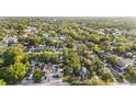 Wide aerial view of the residential neighborhood with lush trees and community pool at 1513 W Mohawk Ave, Tampa, FL 33603