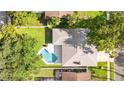 Aerial view of the home's roof and backyard pool and surrounding greenery at 1667 E Orangeside Rd, Palm Harbor, FL 34683