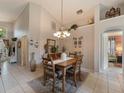 Bright dining room featuring tile floors, decorative chandelier and view to the Gathering room at 18930 Wood Sage Dr, Tampa, FL 33647