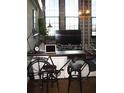 Modern living room with a bicycle used as a desk, and natural light coming from large windows at 2001 E 2Nd Ave # 27, Tampa, FL 33605