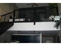 Contemporary apartment loft with railing and stairs overlooking the open living space at 2001 E 2Nd Ave # 27, Tampa, FL 33605