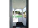 View of the welcoming front porch with white pillars and a tiled floor at 2108 W Comanche Ave, Tampa, FL 33603
