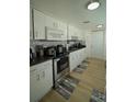 Bright kitchen featuring modern appliances, white cabinetry, and stylish backsplash at 2108 W Comanche Ave, Tampa, FL 33603
