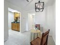 Cozy dining area with tile floors, pendant lighting, and seamless access to the kitchen at 2442 Enterprise Rd # 6, Clearwater, FL 33763