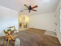 Open-concept living room featuring a ceiling fan, tile flooring, and neutral walls at 2442 Enterprise Rd # 6, Clearwater, FL 33763