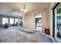 Spacious living room with ample natural light from multiple windows and access to the kitchen, perfect for Gathering living at 2817 Rustic Oaks Dr, Palm Harbor, FL 34684