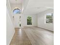 Bright and airy living room with high ceilings, large windows and light-colored floors at 3013 Silvermill Loop # O, Land O Lakes, FL 34638