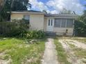 A single Gathering home with a white front door and small front yard at 3110 58Th N Ave, St Petersburg, FL 33714