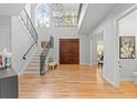 Open foyer featuring wood floors, staircase with wrought iron railing and lots of natural light at 3307 W Knights Ave, Tampa, FL 33611