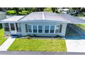 Inviting single-story home boasting a carport and manicured lawn at 37812 Valencia Ave, Zephyrhills, FL 33541