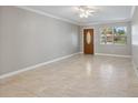 Neutral living room boasts natural light, decorative trim, and tile flooring at 4242 7Th N Ave, St Petersburg, FL 33713