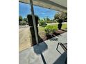 Inviting covered front porch with serene views of the landscaped front yard at 5215 76Th N N St, St Petersburg, FL 33709