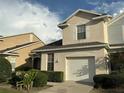 Charming two-story home featuring an attached garage and well-maintained front yard with mature landscaping at 6252 Olivedale Dr, Riverview, FL 33578