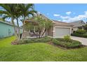 Charming single-story home with a well-manicured lawn and a cozy front porch and a two car garage at 6408 Seasound Dr, Apollo Beach, FL 33572