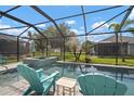 Relaxing screened-in pool area with a spa and comfortable seating, perfect for outdoor enjoyment at 6408 Seasound Dr, Apollo Beach, FL 33572