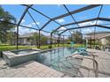 Relaxing screened-in pool area with a spa and comfortable seating, perfect for outdoor enjoyment at 6408 Seasound Dr, Apollo Beach, FL 33572