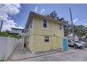 Exterior view of building with a yellow color scheme and access to off street parking at 659 26Th S Ave, St Petersburg, FL 33705