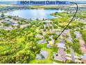 Aerial view of property at 6804 Pleasant Oaks Place near a lake and community pool at 6804 Pleasant Oaks Pl, Riverview, FL 33578