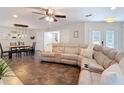 Inviting living room featuring a comfortable sectional sofa, adjacent to a dining area, creating a warm and open living space at 7511 Laurel Oak Ct, Port Richey, FL 34668