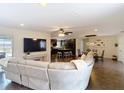 Spacious living area showcasing an open floor plan with views of the kitchen and dining area, ideal for modern living at 7511 Laurel Oak Ct, Port Richey, FL 34668