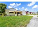 Charming one-story home with a well-maintained lawn and awning-shaded windows at 8720 Briar Patch Dr, Port Richey, FL 34668