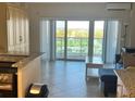 Bright living room with sliding glass doors to the balcony, offering stunning views at 880 Mandalay Ave # C412, Clearwater Beach, FL 33767