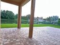 Spacious back porch overlooking a serene backyard with water views and lush landscaping at 1008 Arista Blvd, Valrico, FL 33594