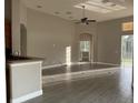 Open-concept living area featuring tile floors, high ceilings, and seamless flow to the outdoors at 1008 Arista Blvd, Valrico, FL 33594