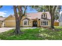Well-maintained single Gathering home featuring a two-car garage and well-maintained lawn at 10206 Evening Trail Dr, Riverview, FL 33569