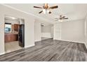 Spacious living room boasts stylish gray wood floors, ceiling fans and a seamless open-concept design at 10375 106Th Ter, Largo, FL 33773