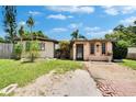 Charming single-story home featuring a well-maintained lawn and brick-paved walkway at 10549 112Th Ave, Largo, FL 33773
