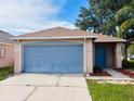 A home with a two-car garage and well-maintained lawn at 11022 Connacht Way, Tampa, FL 33610